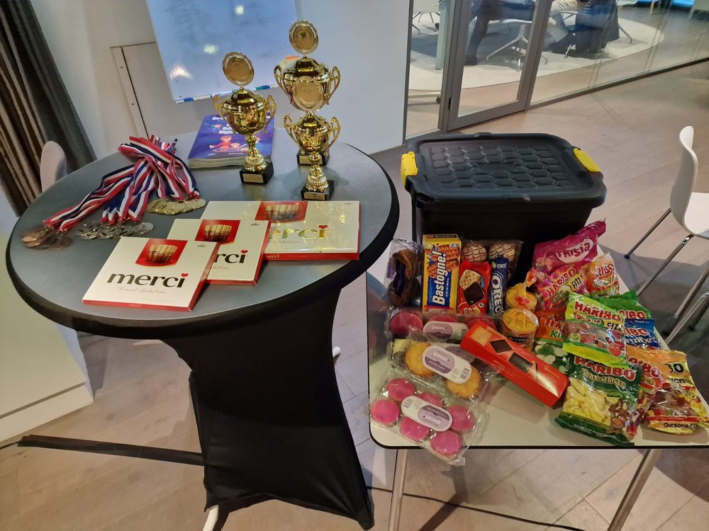 Trophies, medals and a table full of sweets set out as workshop prizes