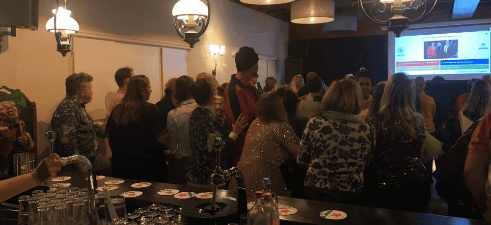 A packed venue follows a quiz round on the big screen