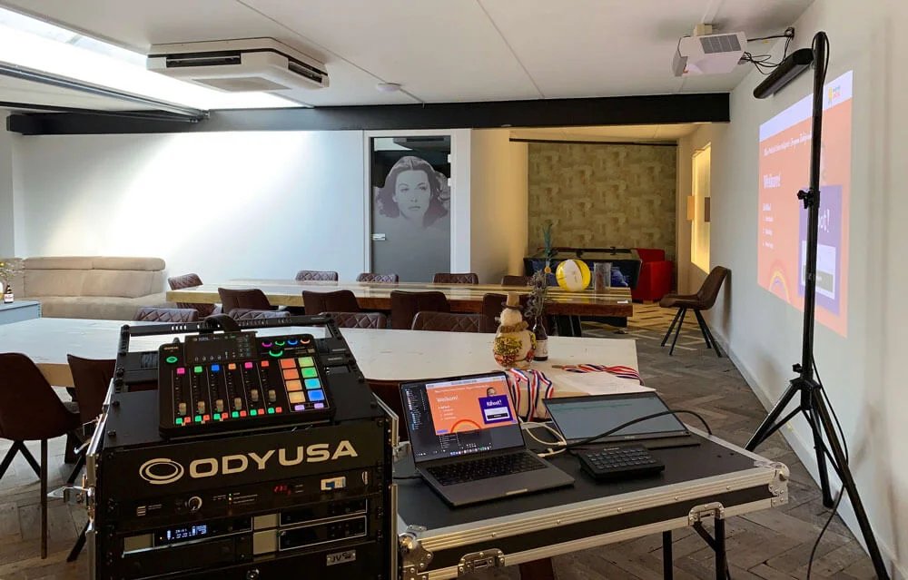 Production setup with laptops, mixer and projector ready to run a session