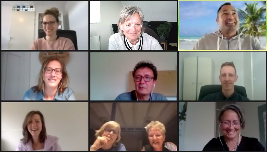 Team members smiling during an online pubquiz workshop call